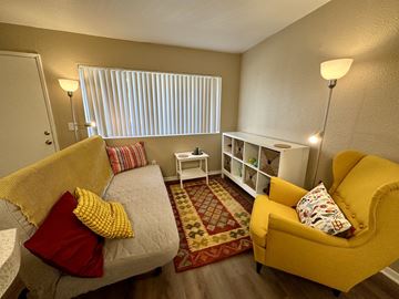 San Rafael apartment for rent - A living room with a yellow chair and a grey couch.