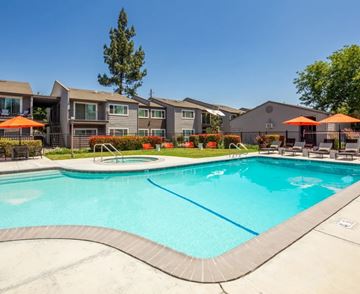 Modesto apartment for rent - A swimming pool in front of a residential area.