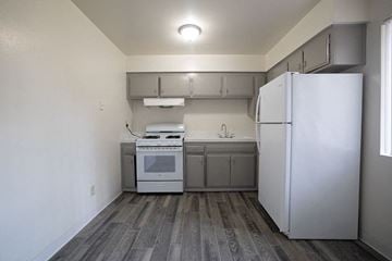 El Cajon apartment for rent - A kitchen with a white fridge and a white oven.