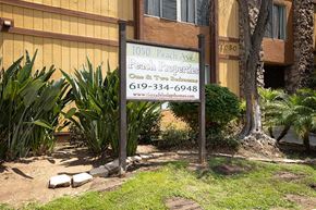 El Cajon apartment for rent - Property sign in landscape near building