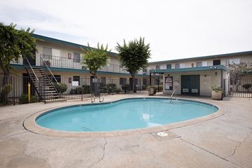 Spring Valley apartment for rent - A small pool in a courtyard surrounded by a fence.