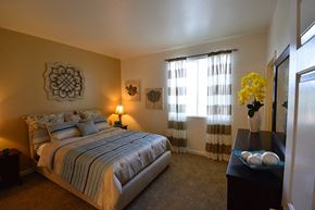 Reno apartment for rent - 3 BR Apartments in Reno, NV - Sky Vista Commons - Bedroom with Large Window, Plush Carpet, Two-toned Walls, a Bed, Nightstand, and Dresser