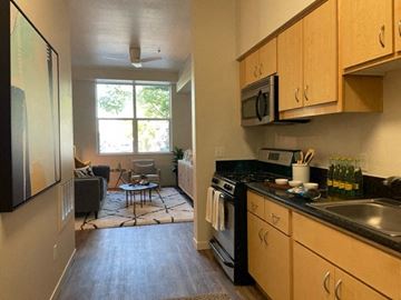 Sacramento townhouse for rent - A kitchen with a black stove top oven and black counter tops.