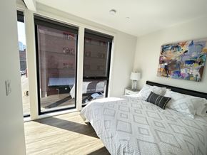 Portland apartment for rent - a bedroom with a bed and two large windows at DOCK 59 APARTMENTS, PORTLAND, OR, 97209