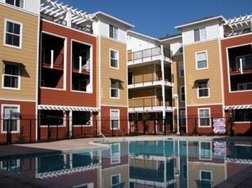San Jose apartment for rent - Apartment complex with a pool in front.