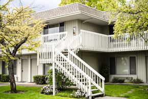 Novato apartment for rent - an exterior view of an apartment building with a white staircase at OTAVON APARTMENTS, Novato California