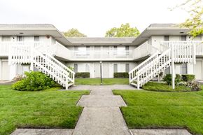 Novato apartment for rent - Building exterior with a beautiful lawn near the sidewalk at OTAVON APARTMENTS, California