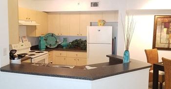 Apartment home kitchen area with white appliances