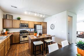 Las Vegas apartment for rent - a kitchen with wooden cabinets and a table with chairs at EVERETT APARTMENT HOMES, Las Vegas, Nevada