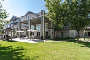 Bend apartment for rent - A large building with a green lawn in front.