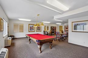 Burien apartment for rent - A room with a pool table and a bookshelf.
