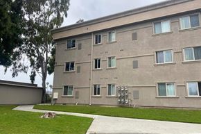 Los Angeles apartment for rent - the side of a building with grass and a sidewalk
