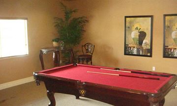 Tampa apartment for rent - a red pool table in a living room