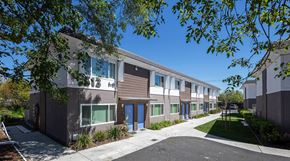 Vacaville apartment for rent - a picture of a building with blue doors and brown and white siding at MEADOWS HOLLY, VACAVILLE, 95688