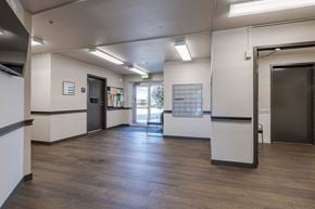 Kent apartment for rent - a lobby with a wood floor and white walls and doors at Webster Court Senior Apartments, Washington