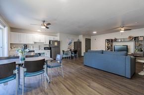 Kent apartment for rent - a living room with a couch and a table with chairs at Webster Court Senior Apartments, Kent, WA 98032