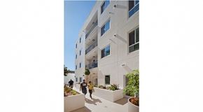 Los Angeles apartment for rent - a large white building with people walking in front of it