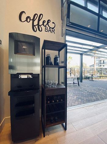 A coffee bar with a television and a refrigerator