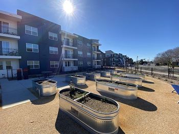 A view of the community garden at the reserve at south coast apartments in santa ana