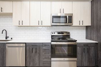 A kitchen with a stove and a microwave