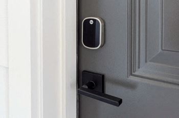 A black and white door handle on a gray door