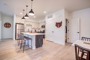 Santa Rosa apartment for rent - a kitchen with white cabinets and a large island with a breakfast barat 38° NORTH, Santa Rosa California