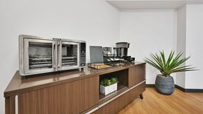 Salt Lake City apartment for rent - A modern kitchen with a wooden cabinet and a stainless steel oven.