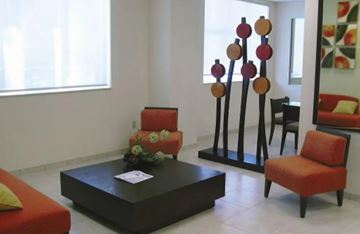 Fort Lauderdale apartment for rent - A living room with a red couch, a coffee table, and a chair.