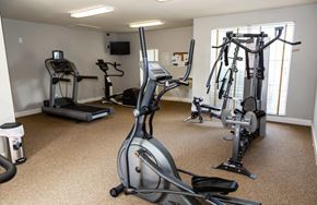 Crestview apartment for rent - A well-equipped gym with treadmills, elliptical machines, and stationary bikes at ADDISON PLACE, CRESTVIEW, FL
