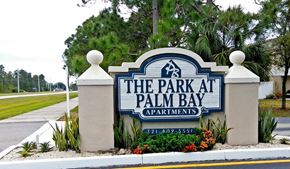 Palm Bay apartment for rent - The sign for The Park at Palm Bay Apartments is blue and white.