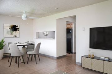 Vancouver apartment for rent - a living room and dining room with a table and a television