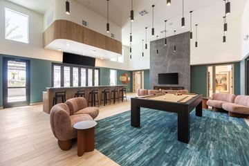 Las Vegas apartment for rent - A modern living room with a pool table and a fireplace.
