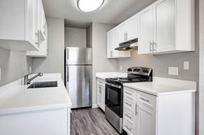 Suisun City apartment for rent - A modern kitchen with white cabinets and stainless steel appliances at The Henley Apartments, Suisun City, CA, 94585