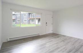 Tigard apartment for rent - A room with a large window overlooking apartment buildings.at Tigardville Apartments, Oregon