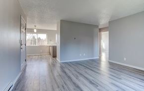 Tigard apartment for rent - A spacious room with wood flooring and white walls.at Tigardville Apartments, Oregon, 97223
