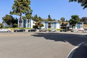 La Mesa apartment for rent - A parking lot with cars and a building in the background.