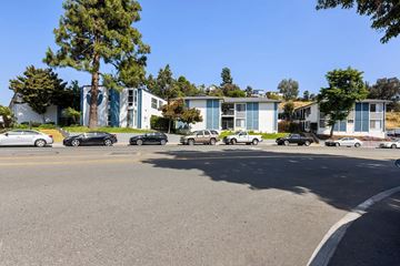 La Mesa apartment for rent - A parking lot with cars and a building in the background.