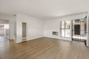 La Mesa apartment for rent - A spacious room with wooden flooring and white walls.