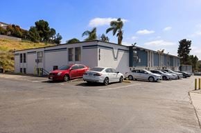 La Mesa apartment for rent - A parking lot with cars and a building in the background.
