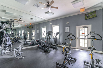 A spacious gym with a variety of exercise equipment.