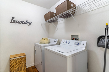 A small laundry room with a washer and dryer.