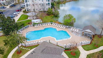 A large swimming pool surrounded by a white fence.