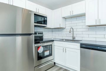 Las Vegas apartment for rent - A modern kitchen with a stainless steel refrigerator, oven, and dishwasher.