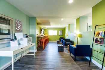 A living room with green walls and blue and yellow furniture