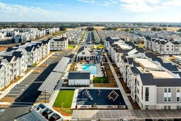 Roseville apartment for rent - A large residential complex with a swimming pool and solar panels.