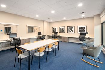 A conference room with a long table and chairs.