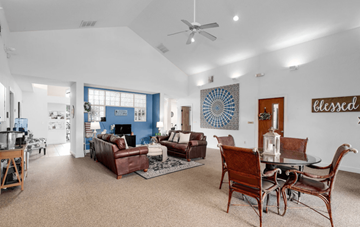 Orlando apartment for rent - A living room with a brown sofa and a glass table.