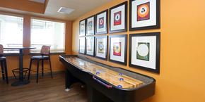 Colorado Springs apartment for rent - A room with a pool table and framed pictures on the wall.