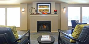 Colorado Springs apartment for rent - A living room with a fireplace and two chairs.