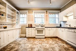 Tacoma apartment for rent - kitchen with white cabinets and a stove and a window at THE MILLER, TACOMA, WA